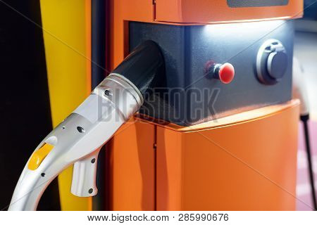 Electric Car Fast Charging Station At Indoor Underground Parking. Power Supply Point Network For Hyb