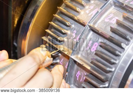 Close Up Hand Of Operator Use A Grinder Tool To Polish And Decorate Blade Of Roller Die Cut Or Workp