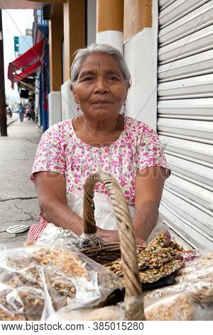 Oaxaca, Mexico - May 8, 2015: Elderly Woman Selling Traditional Mexican Sweets On The Street In Oaxa