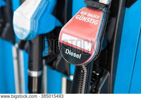 Diesel Fuel Pumps At Petrol Station With German Text „auf Dauer Günstig