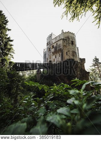 Burg Grimmenstein Castle In Lower Austria Framed By Green Leaves