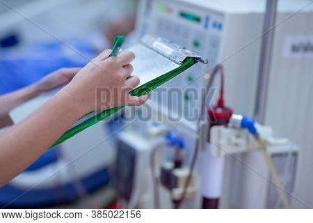 The specialist are checking continuous renal replacement therapy equipment and injection pump and he