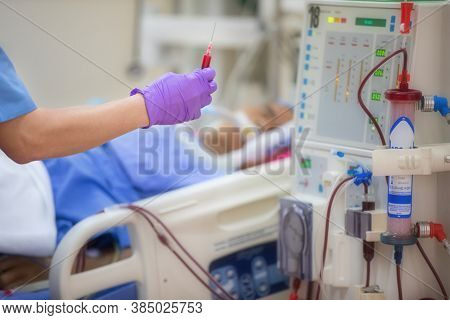 The specialist are doing continuous renal replacement therapy equipment and injection pump.