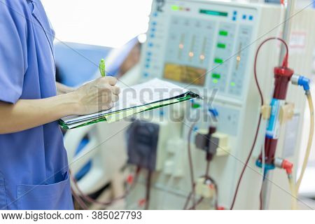 The specialist are checking continuous renal replacement therapy equipment and injection pump and he