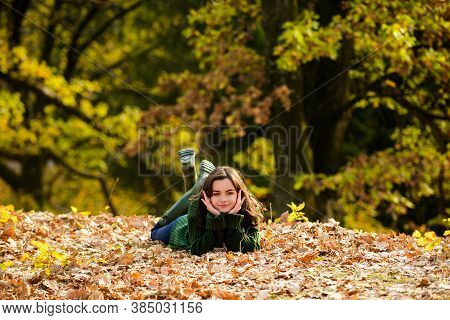Sportrait Of A Smiling Teenager. Young Teen Girl Looking To Camera Miling Teenage Girl Lying On Autu