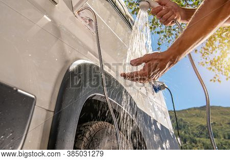 Rv Camper Van Outdoor Shower Taking. Caucasian Men Preparing For Shower While On Wilderness Boondock