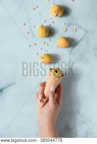 Creative Flat Lay With Autumn Yellow Quince Friuts And Sugar Ice Particles Coming Out Of Ice Cream W