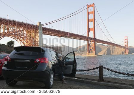 View Of A Girl Coming Out Of The Car Near Golden Gate In San Francisco