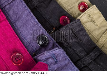 Fragment Of Four Cotton Twill Pants Red, Blue, Black, Beige With Open Buttons.