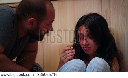 Traumatised Wife Smoking And Crying Sitting On The Floor. Abused Terrified Beaten Woman Covered In B