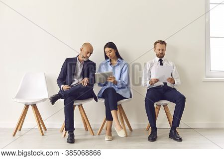 Group Of Business People Sitting With Official Reports And Waiting For Directors Invitation