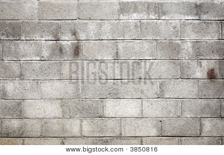 더러운 회색 바람 블록 벽 배경입니다.