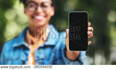 Unrecognizable Black Woman Showing Cellphone Empty Screen Recommending Application Standing Outdside