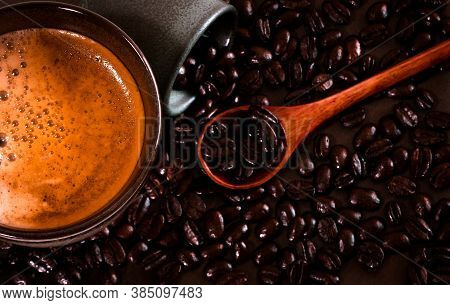 Hot Coffee With Roasted Coffee Beans On A Wooden Spoon. Focus On The Fizzy Coffee Cup. Bangkok, Thai