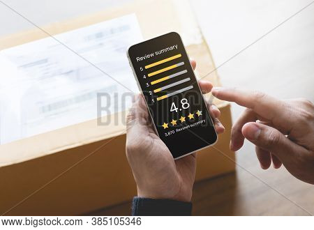 Consumer Reviews Concepts With Young Person Putting Report Score On Application Smartphone And Packa