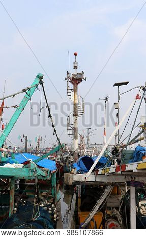 Pole Tower For Signal Light Among Many Indonesia Fishing Boats Moored In The Port Harbor.