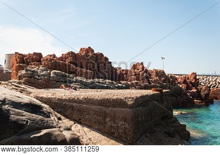 Sardinia Coastline: Typical Red Rocks And Cliffs Near Sea In Arbatax; Italy