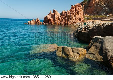 Sardinia Coastline: Typical Red Rocks And Cliffs Near Sea In Arbatax; Italy