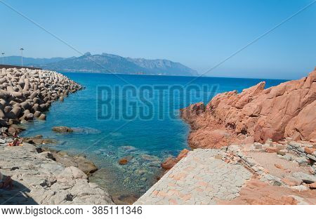 Sardinia Coastline: Typical Red Rocks And Cliffs Near Sea In Arbatax; Italy