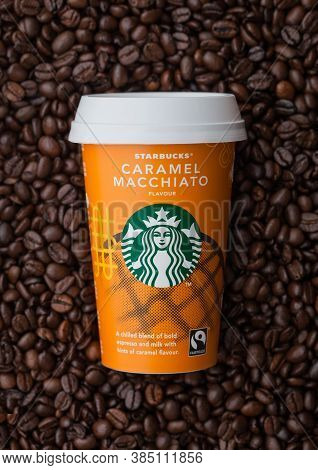 London, Uk - September 09, 2020: Paper Cup Of Starbucks Caramel Macciato Iced Cold Coffee On Top Of 