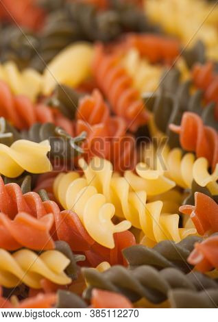 Raw Homemade Tricolore Fusilli Pasta As Texture Background. Macro