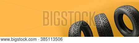 Three Friction Tires, Winter Season Re-booting, On A Bright Orange Background. Copy Space Panorama F