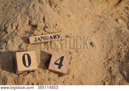 January 4, Number Cube With A Sand Background.