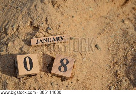 January 8, Number Cube With A Sand Background.