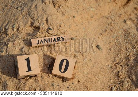 January 10, Number Cube With A Sand Background.