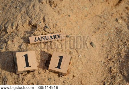 January 11, Number Cube With A Sand Background.