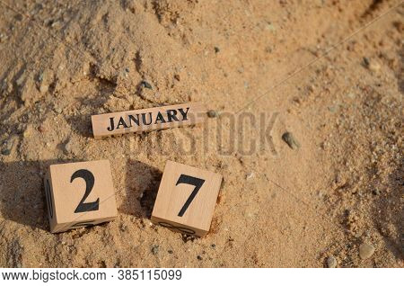 January 27, Number Cube With A Sand Background.