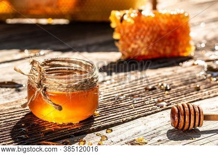 Honey In Jar With Honey Dipper, Honeycombs With Full Cells Of Honey On Vintage Wooden Background.