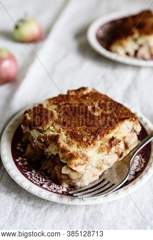 Apple And Cheese Cobbler Crisp. Cobbler Or Crumble Dessert With Apples On Plates On Beige Linen Tabl