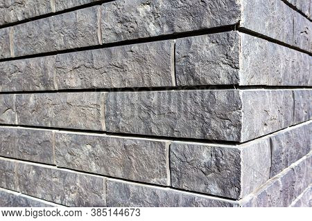 The Corner Of The House Is Made Of Gray Tiles That Imitate Brickwork. Modern Finishing Material. The