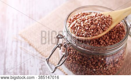 Transparent Glass Jar With Buckwheat On The Table. Quarantine Product Stock