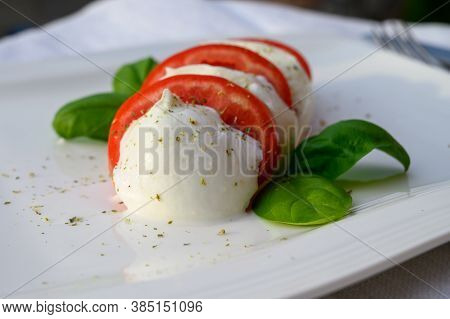 Caprese Salad Made With Fresh Soft White Italian Cheese Mozzarella Buffalo, Green Basil, Red Tomatoe