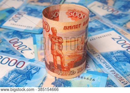 Russian Banknote 5000 Rubles Is On The Field Of Banknotes 2000 Rubles. Close-up