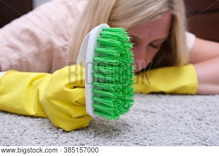 Woman In Yellow Gloves With A Green Brush Is So Tired Of Cleaning And Brushing Carpet, Removing Stai