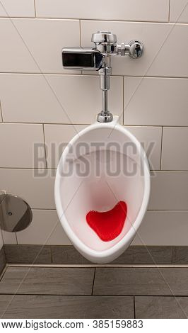 Toilet Urinal Has Been Cleaned And A New Urinal Screen Has Been Installed