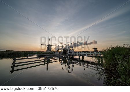In Rotterdam There Is A Municipality With Wind Mills Of Kinderdijk With A Drawbridge.