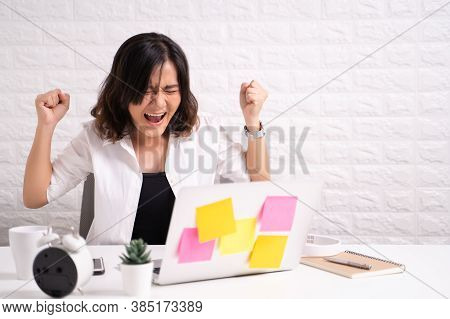 Angry Businesswoman Working At Home Office At Brick Wall