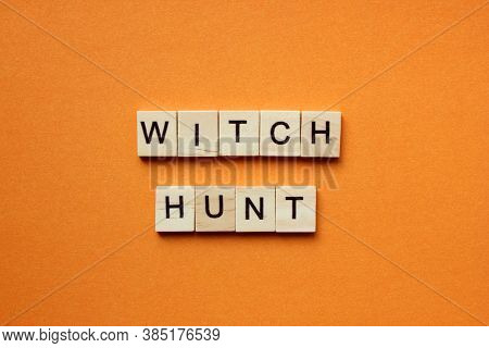 Words Witch Hunt. Wooden Blocks With An Inscription On An Orange Background. Bulletin Board. The Con