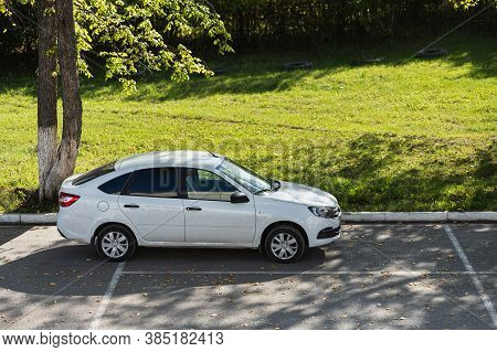 Novosibirsk, Russia - September 12, 2020: White  Lada Granta,  Side View.  New Popular Sedan Made In