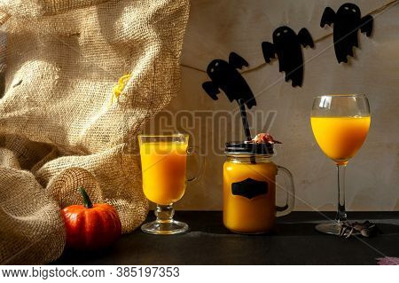 Orange Halloween Mococktails And Holiday Decor On A Dark Mystical Autumn Background. Chosts On Backg
