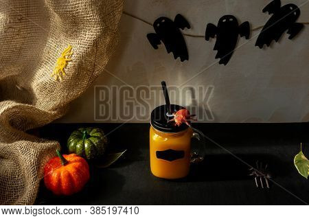 Orange Halloween Mococktail And Holiday Decor On A Dark Mystical Autumn Background. Chosts On Backgr