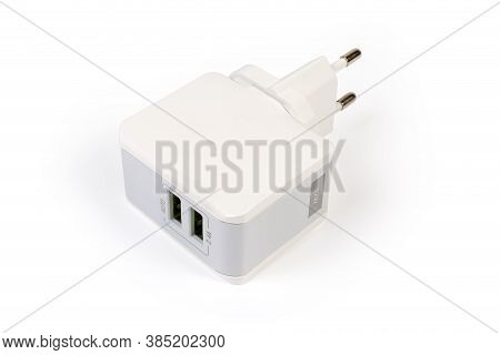 Ac Adaptor For Mobile Equipment Batteries Charging With Two Output Usb Ports On A White Background