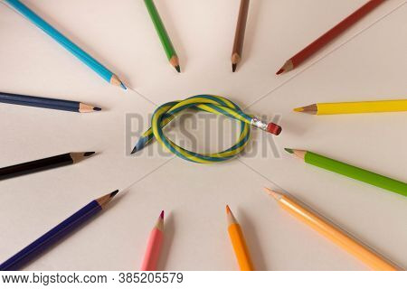 Flexible Pencil And A Set Of Colored Pencils On A Light Background. Selective Focus