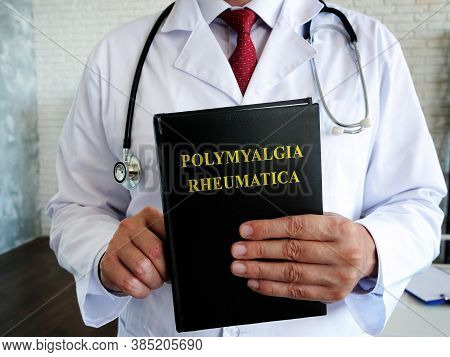 The Doctor Is Holding A Book About The Polymyalgia Rheumatica Disease.