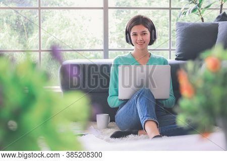 Young And Beautiful Cute Woman Half Race Thai-german Wearing Headphone And Using Laptop Notebook Com