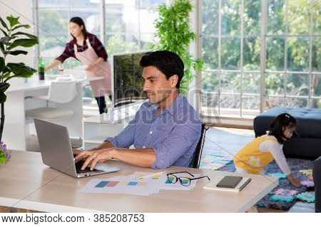 Mixed Race Family Staying Together, Caucasian Dad Working At Home At Desk While Mother Prepare Food 
